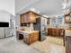 Spacious kitchen features wood cabinetry, stainless steel appliances, and tile flooring at 108 Parkridge Dr, Danville, IN 46122