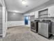 Basement laundry room featuring side-by-side washer and dryer units, as well as storage cabinets at 108 Parkridge Dr, Danville, IN 46122