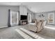 Bright living room with vaulted ceilings, plush carpeting, and large windows, offering a cozy yet spacious feel at 108 Parkridge Dr, Danville, IN 46122