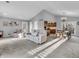 Open living room with vaulted ceilings, plush carpet, and a view into the kitchen and dining areas at 108 Parkridge Dr, Danville, IN 46122