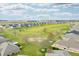 High-angle showcasing manicured golf course community with tree-lined streets and lush green spaces at 1120 Constitution Dr, Edinburgh, IN 46124