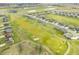 Scenic aerial view of a neighborhood alongside a golf course and serene ponds at 1120 Constitution Dr, Edinburgh, IN 46124
