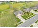 Aerial view of a brick home with a green lawn in a residential neighborhood with trees and walking paths at 1120 Constitution Dr, Edinburgh, IN 46124