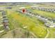 Scenic aerial view of a neighborhood alongside a golf course and serene ponds at 1120 Constitution Dr, Edinburgh, IN 46124