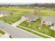 Aerial view of a brick home with a green lawn, driveway, sidewalk, and street in a residential neighborhood at 1120 Constitution Dr, Edinburgh, IN 46124