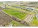 Expansive aerial view showcasing land with newly constructed residential development with pond and open field at 1120 Constitution Dr, Edinburgh, IN 46124