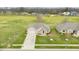 Aerial view of a brick home with a green lawn, driveway, sidewalk, and street in a residential neighborhood at 1120 Constitution Dr, Edinburgh, IN 46124