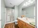 Bathroom featuring a wood floor, shower and nice vanity with a large mirror at 1120 Constitution Dr, Edinburgh, IN 46124