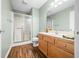Bathroom featuring a wood floor, shower and nice vanity with a large mirror at 1120 Constitution Dr, Edinburgh, IN 46124