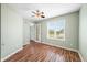 Charming bedroom featuring wood floors, bright natural light, and a modern ceiling fan at 1120 Constitution Dr, Edinburgh, IN 46124
