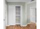 Walk-in closet with white shelving and wood look flooring at 1120 Constitution Dr, Edinburgh, IN 46124