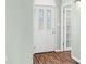 Bright entryway with a decorative glass front door and warm hardwood flooring at 1120 Constitution Dr, Edinburgh, IN 46124