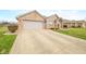 Charming brick home featuring a two-car garage and beautifully landscaped front yard at 1120 Constitution Dr, Edinburgh, IN 46124