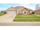 Charming brick home featuring a two-car garage and beautifully landscaped front yard at 1120 Constitution Dr, Edinburgh, IN 46124
