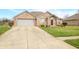 Charming brick home featuring a two-car garage and beautifully landscaped front yard at 1120 Constitution Dr, Edinburgh, IN 46124