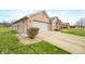 Charming brick home featuring a two-car garage and beautifully landscaped front yard at 1120 Constitution Dr, Edinburgh, IN 46124
