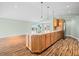 Kitchen island with bar seating, pendant lights, and hardwood flooring in an open layout at 1120 Constitution Dr, Edinburgh, IN 46124