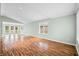 Bright living room featuring a vaulted ceiling, hardwood floors, and access to the backyard at 1120 Constitution Dr, Edinburgh, IN 46124