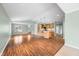 Open-concept living space featuring hardwood floors, lots of light, and a kitchen island at 1120 Constitution Dr, Edinburgh, IN 46124
