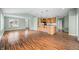 Bright, open-concept living space with hardwood floors and an island bar with seating at 1120 Constitution Dr, Edinburgh, IN 46124