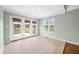 Bright sunroom with tile flooring, multiple windows, and access to the backyard at 1120 Constitution Dr, Edinburgh, IN 46124