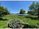 Beautiful backyard featuring lush landscaping and lake views at 11967 Windpointe Pass, Carmel, IN 46033