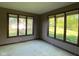 Bright bedroom with multiple windows providing ample natural light and views of the surrounding greenery at 11967 Windpointe Pass, Carmel, IN 46033