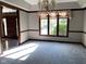 Elegant dining room with a classic chandelier, large windows, and neutral tones throughout at 11967 Windpointe Pass, Carmel, IN 46033