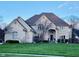 Elegant two-story brick home featuring a lush lawn, well-maintained landscaping, and an inviting entrance at 11967 Windpointe Pass, Carmel, IN 46033