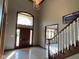 Grand foyer with a striking staircase, elegant chandelier, and abundant natural light at 11967 Windpointe Pass, Carmel, IN 46033