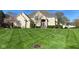 Beautiful brick home showcasing a well-manicured lawn and lush landscaping at 11967 Windpointe Pass, Carmel, IN 46033