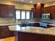 Gourmet kitchen featuring granite countertops, custom cabinets, and stainless steel appliances at 11967 Windpointe Pass, Carmel, IN 46033