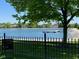 Scenic lake view from the property, featuring a dock, lush greenery, and a serene atmosphere at 11967 Windpointe Pass, Carmel, IN 46033
