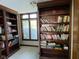 Cozy library space featuring custom built-in wooden bookshelves with a window offering natural light at 11967 Windpointe Pass, Carmel, IN 46033