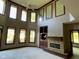 Spacious living room features a fireplace, built-in shelving, and plenty of natural light from the many windows at 11967 Windpointe Pass, Carmel, IN 46033