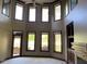 Sun-lit living room with soaring ceilings, fireplace, and large windows overlooking the yard at 11967 Windpointe Pass, Carmel, IN 46033