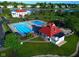 Community pool and clubhouse overlooking a picturesque lake, perfect for relaxation and recreation at 11967 Windpointe Pass, Carmel, IN 46033
