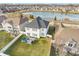 High-angle view of a home with a spacious backyard, patio, and proximity to a scenic lake and walking trails at 1283 Cliff View Dr, Westfield, IN 46074