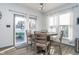 Bright dining area with modern table and chairs, leading to an outdoor patio at 1283 Cliff View Dr, Westfield, IN 46074