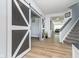 Hallway featuring a decorative sliding barn door and stylish flooring at 1283 Cliff View Dr, Westfield, IN 46074