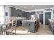 Modern kitchen boasts stainless appliances, gray cabinets, and island seating for casual dining at 1283 Cliff View Dr, Westfield, IN 46074