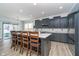 Modern kitchen featuring dark cabinetry, stainless appliances, and a large island with seating at 1283 Cliff View Dr, Westfield, IN 46074