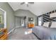 Bright main bedroom with modern furniture, gray carpet, and a stylishly decorated accent wall at 1283 Cliff View Dr, Westfield, IN 46074