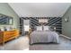 Comfortable main bedroom featuring modern decor, a decorative accent wall, and neutral gray carpet at 1283 Cliff View Dr, Westfield, IN 46074