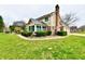Two-story home with brick and siding, featuring a sunroom and well-maintained landscaping at 12917 Brighton Ln, Carmel, IN 46032