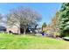 Backyard view features a stone patio, mature trees and a well-maintained lawn at 12917 Brighton Ln, Carmel, IN 46032