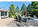 Charming backyard patio featuring a dining set, bench, and lush greenery, creating a serene outdoor space at 12917 Brighton Ln, Carmel, IN 46032