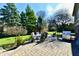Well-maintained backyard patio with dining set, grill, and mature trees, offering ample space for relaxation at 12917 Brighton Ln, Carmel, IN 46032