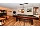 Finished basement has a large pool table and a kitchenette with barstool seating at 12917 Brighton Ln, Carmel, IN 46032