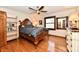 Traditional bedroom features hardwood floors, a ceiling fan, and a wooden furniture set at 12917 Brighton Ln, Carmel, IN 46032